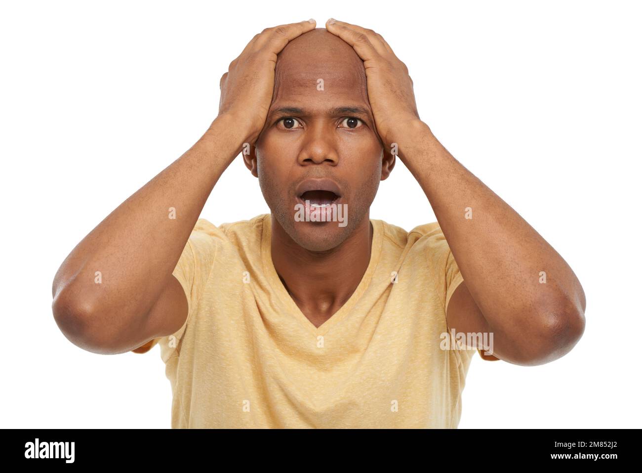 I cant believe it. A handsome African-American man looking at the camera in disbelief with his hands on his head. Stock Photo