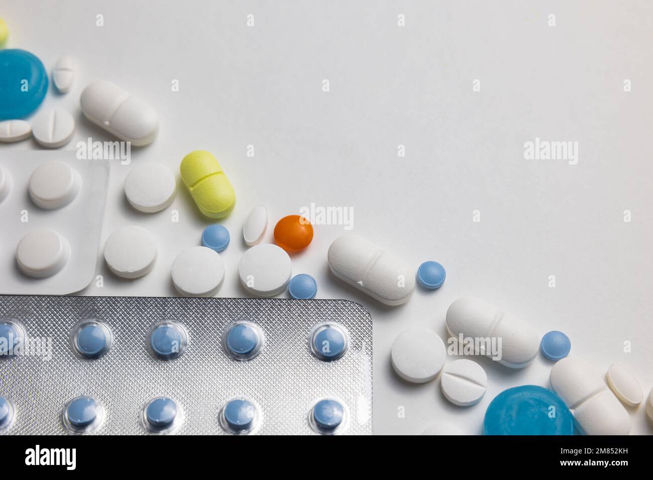 Medicine or healthcare concept photo. Various pills or tablets on white background with copy space for texts. Stock Photo