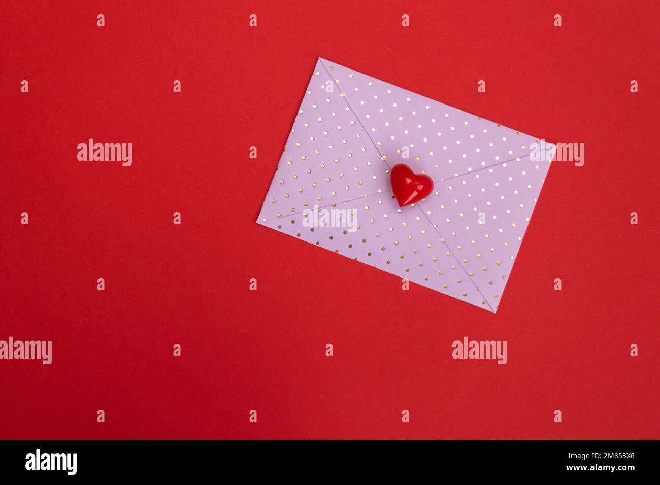 Valentines day red heart on pink dots envelope. Vivid color. Valentine's day concept. Copy space. Space for text. Stock Photo
