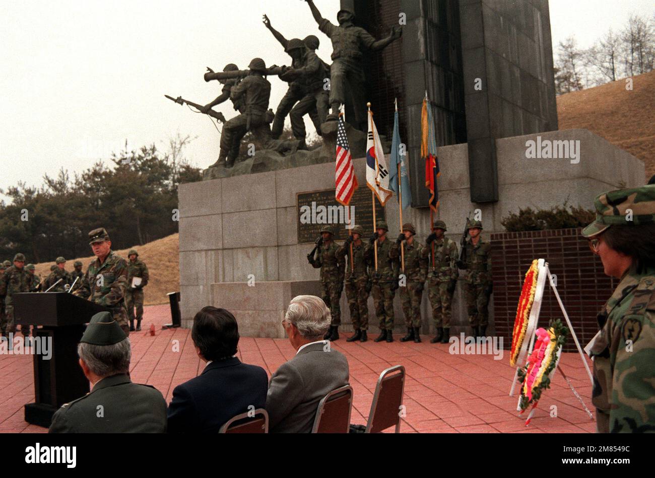 MAJ. GEN. Claude M. Kicklighter, commander, 25th Inf. Div., speaks during a wreath laying ceremony at the Task Force Smith Memorial which commemorates the first major battle of the Korean War. Attending the ceremony were former members of the 24th and 25th Infantry Division and in the background stands a color guard composed of members of the 1ST Bn., 21st Inf., 25th Inf. Div., deployed from Hawaii to participate in the joint U.S./Korean Exercise Team Spirit '86. Subject Operation/Series: TEAM SPIRIT '86 Base: Osan City Country: Korea Stock Photo