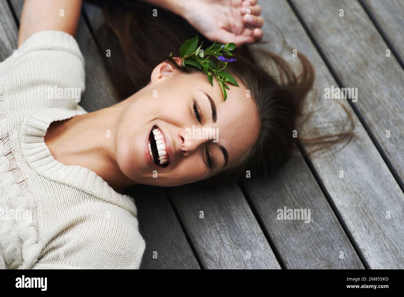 Filled with positive natural energy. An attractive young woman lying on her porch. Stock Photo