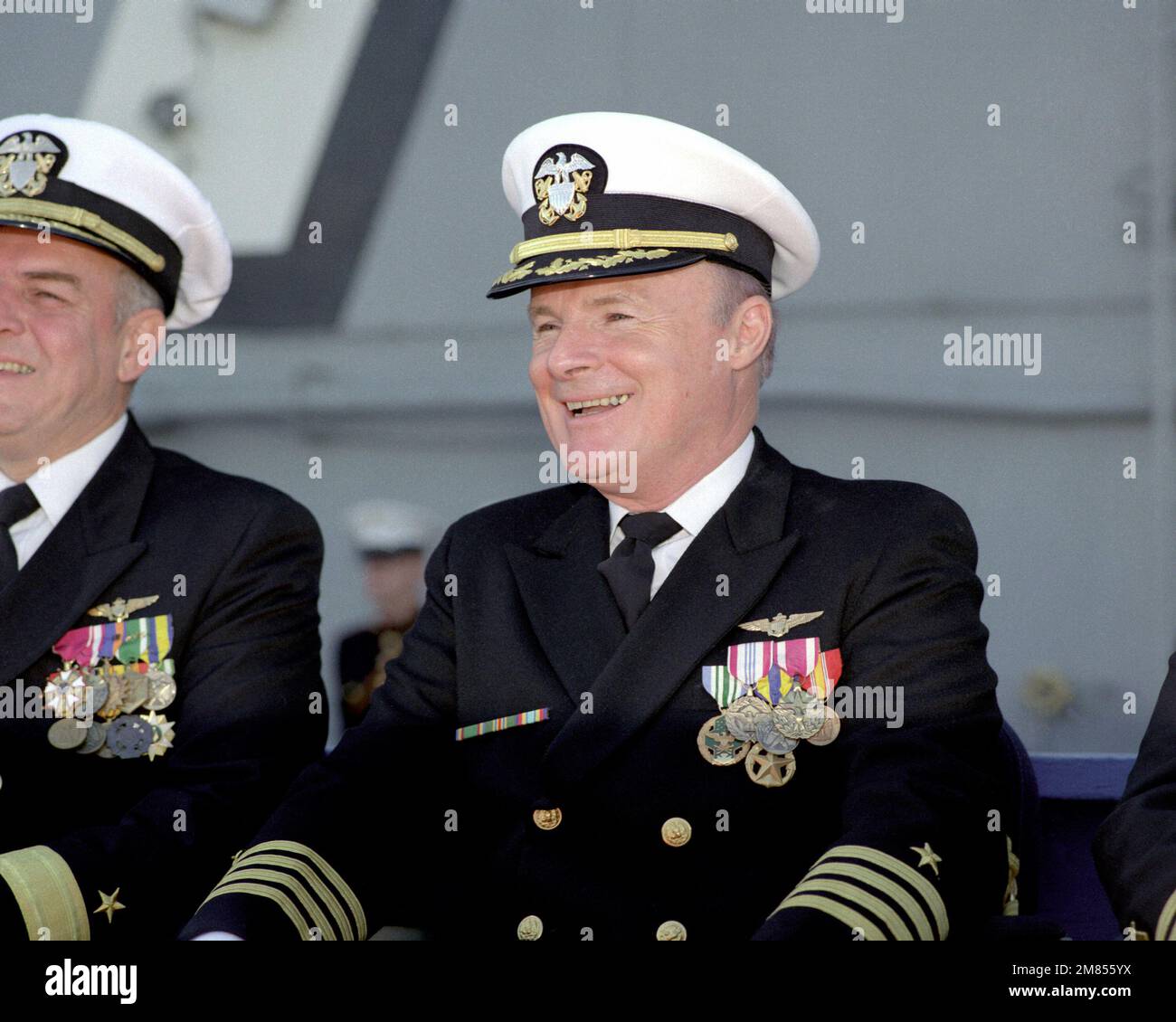 CAPT. D. O'Brien Jr. listens to a speaker during the change of