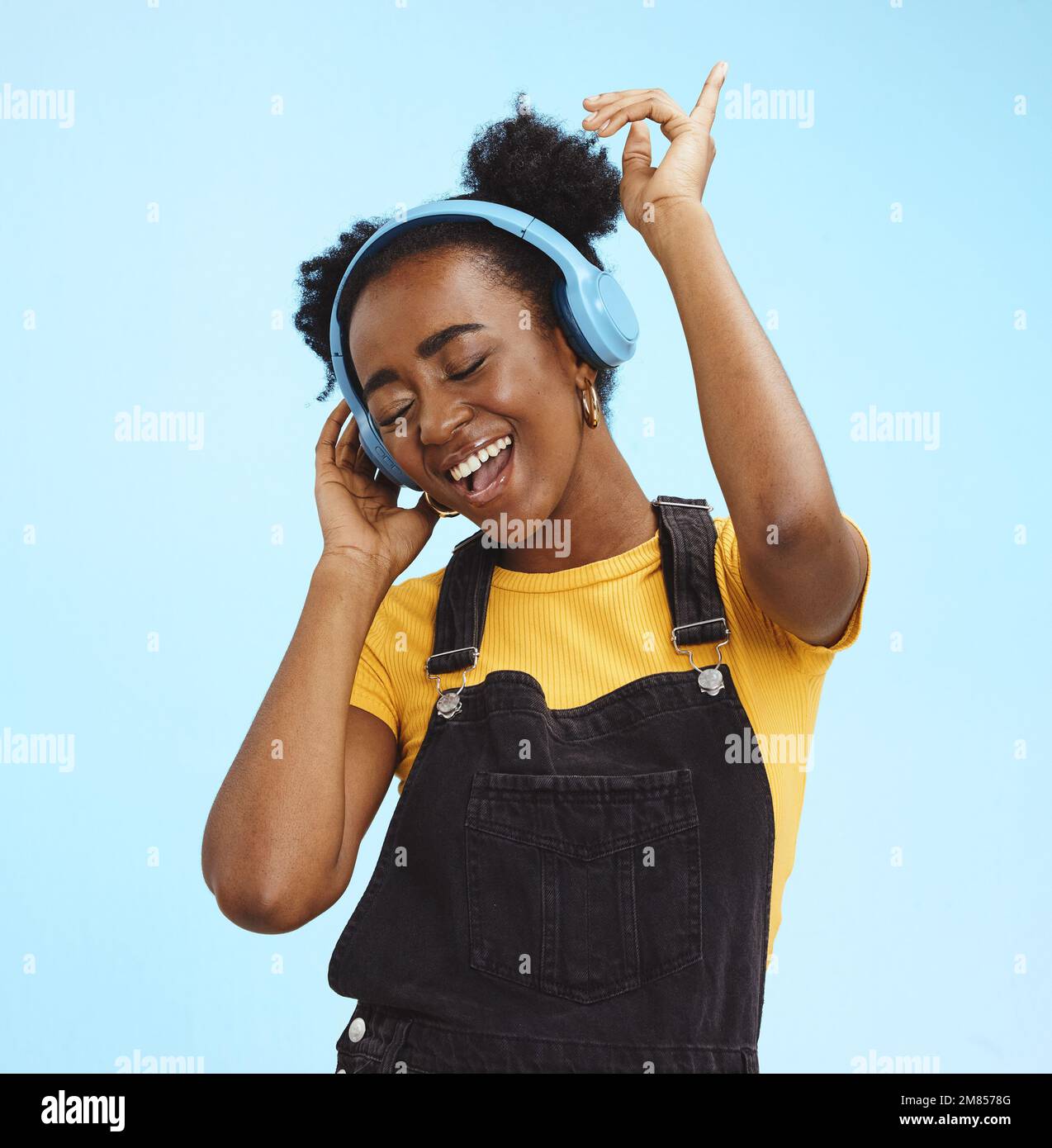 Music, dance and freedom with black woman and headphones, singing for relax, celebration and streaming. Audio, smile and technology with girl Stock Photo