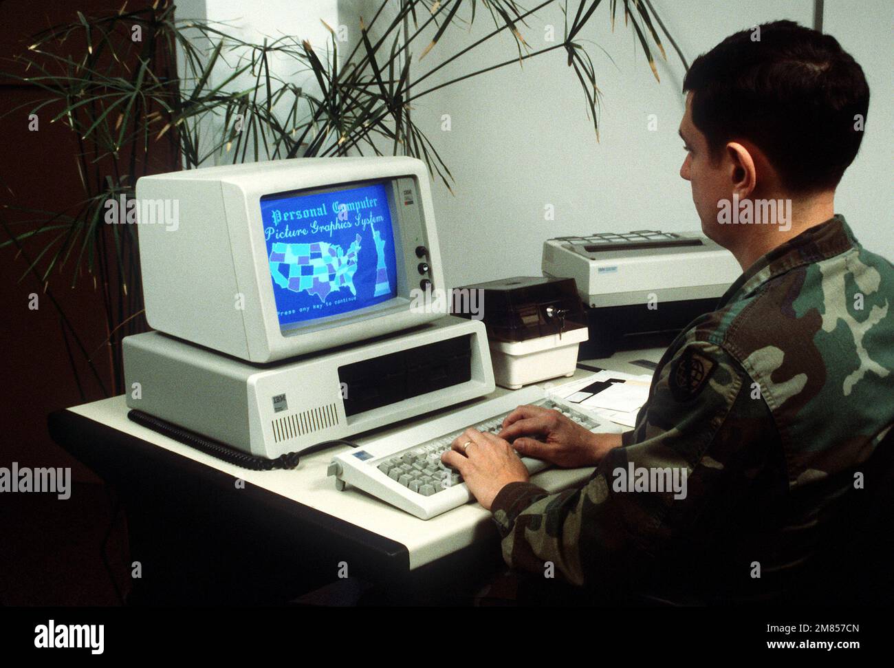 A soldier operates an IBM personal computer at the Theater Microcomputer Information Center. Base: Pentagon State: District Of Columbia (DC) Country: United States Of America (USA) Stock Photo