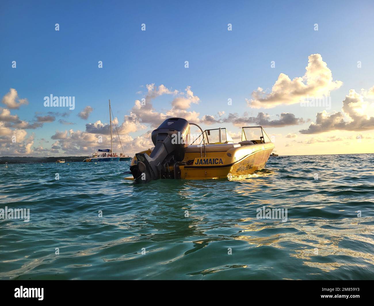 Boat floating in Negril, Jamaica during sunset Stock Photo Alamy
