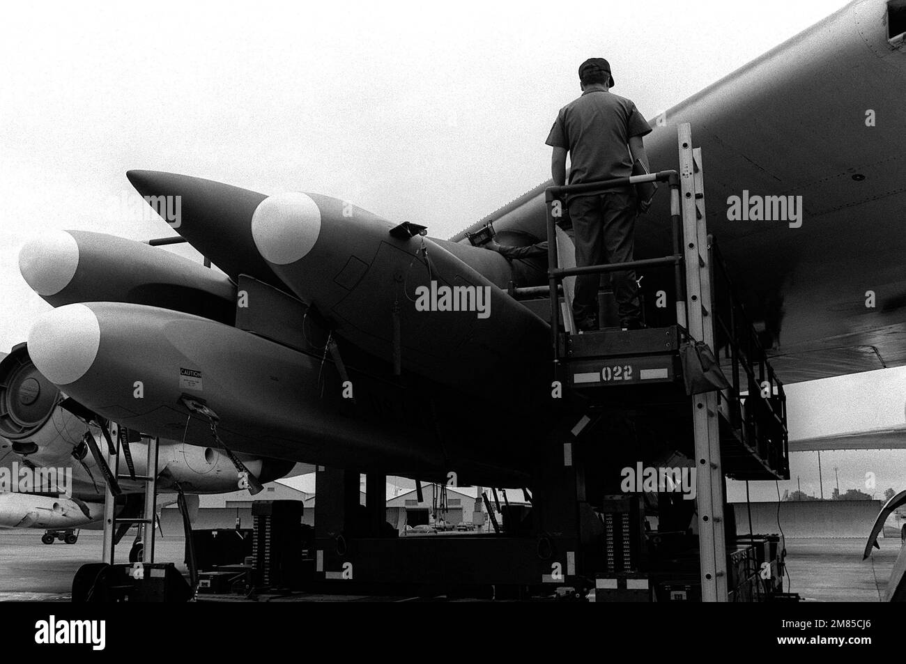 Munitions maintenance personnel secure AGM-86B air-launched cruise missiles to the wing pylon on a B-52G Stratofortress aircraft. Base: Griffiss Air Force Base State: New York (NY) Country: United States Of America (USA) Stock Photo