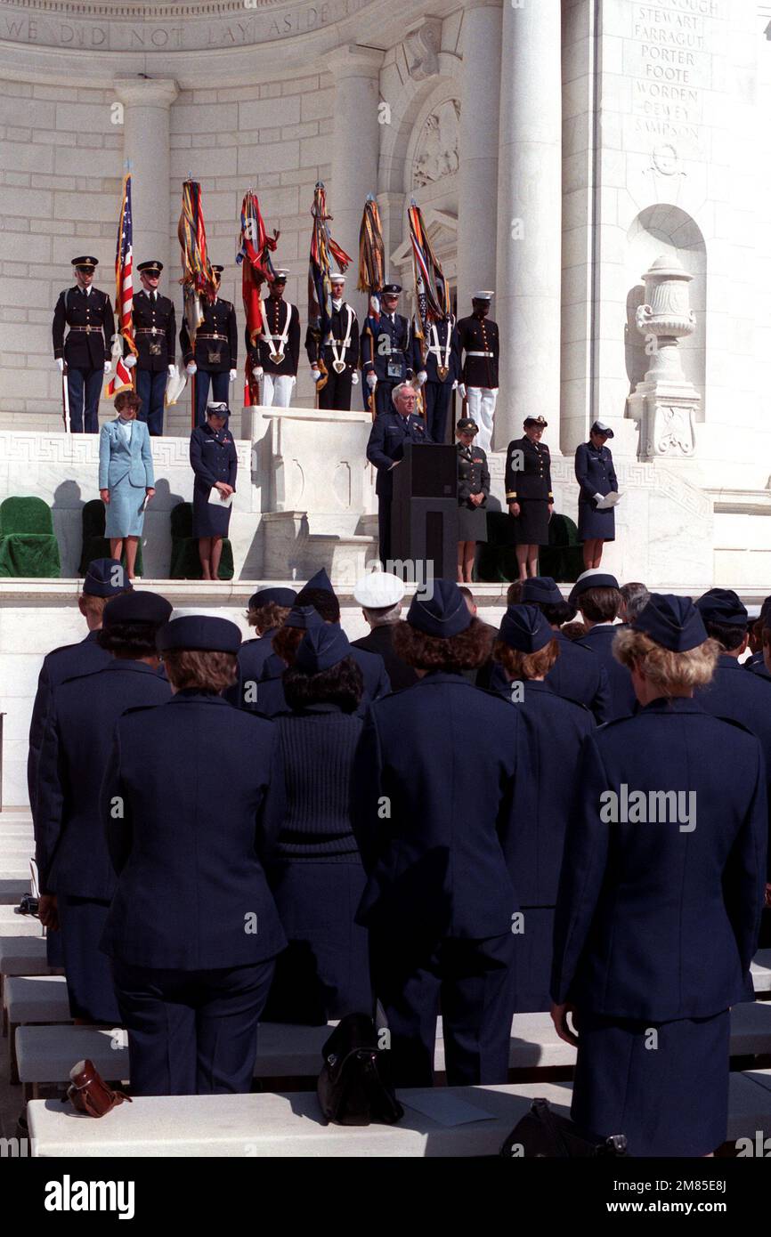 Chaplain (Brig. GEN.) John P. McDonough, deputy chief of chaplains, USAF, gives the invocation during the 1986 Military Nurse Memorial Service at Arlington National Cemetery. Standing on the platform are, left to right, Karen P. Keesling, principal deputy assistant secretary of the Air Force; Brig. GEN. Carmelita Schimmenti, chief of the Air Force Nurse Corps; Brig. GEN. Connie L. Slewitzke, chief of the Army Nurse Corps; Rear Adm. Mary J. Nielubowicz, chief of the Navy Nurse Corps; and CAPT. Virginia F. Connelly, moderator. Base: Arlington State: Virginia (VA) Country: United States Of Americ Stock Photo