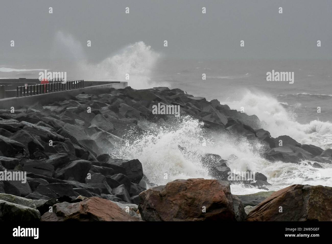 West Bay, Dorset, UK.  12th January 2023.  UK Weather.  Rough seas crash against the sea defences at West Bay in Dorset on a wet and windy day.  Picture Credit: Graham Hunt/Alamy Live News Stock Photo