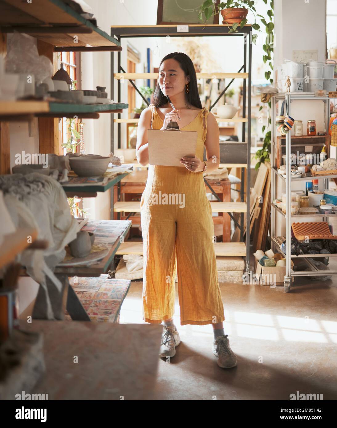 Woman, and planning notes for pottery checklist, inventory and