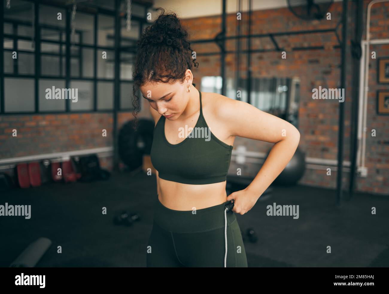 Fitness, exercise and woman at gym to check body progess after training for health, balance and wellness. A young sports female or athlete strong and Stock Photo