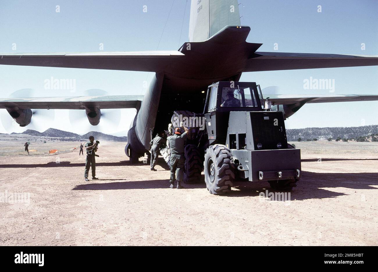 U.S. Air Force reserve personnel use a Case MW20BFL forklift truck to  unload a pallet of supplies from a C-130 Hercules aircraft during an engine  running offload (ERO) exercise with members of