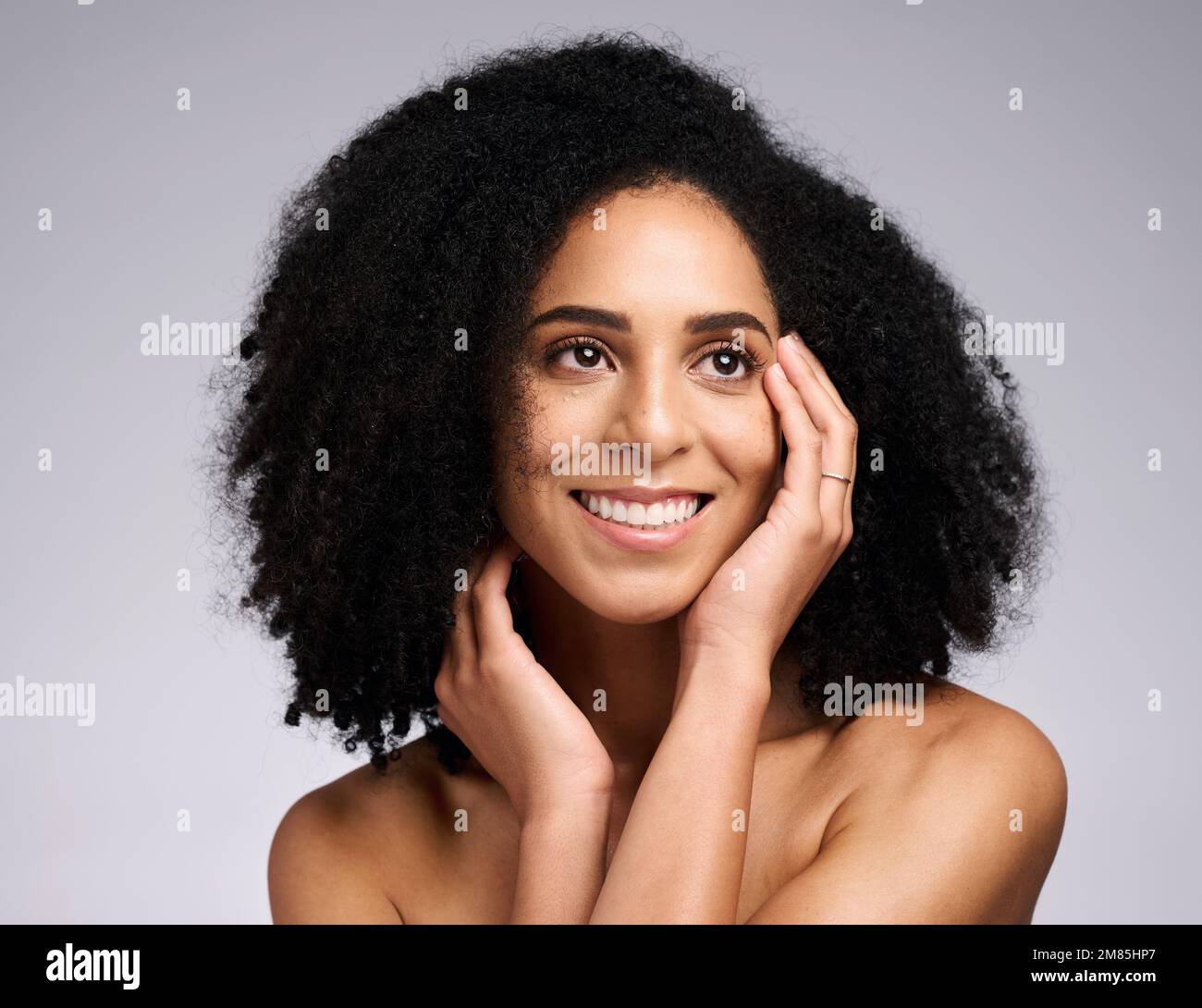 Black woman, beauty and face skincare with a smile, glow and happiness for  clean skin on grey studio background. Aesthetic model with afro hair and  Stock Photo - Alamy