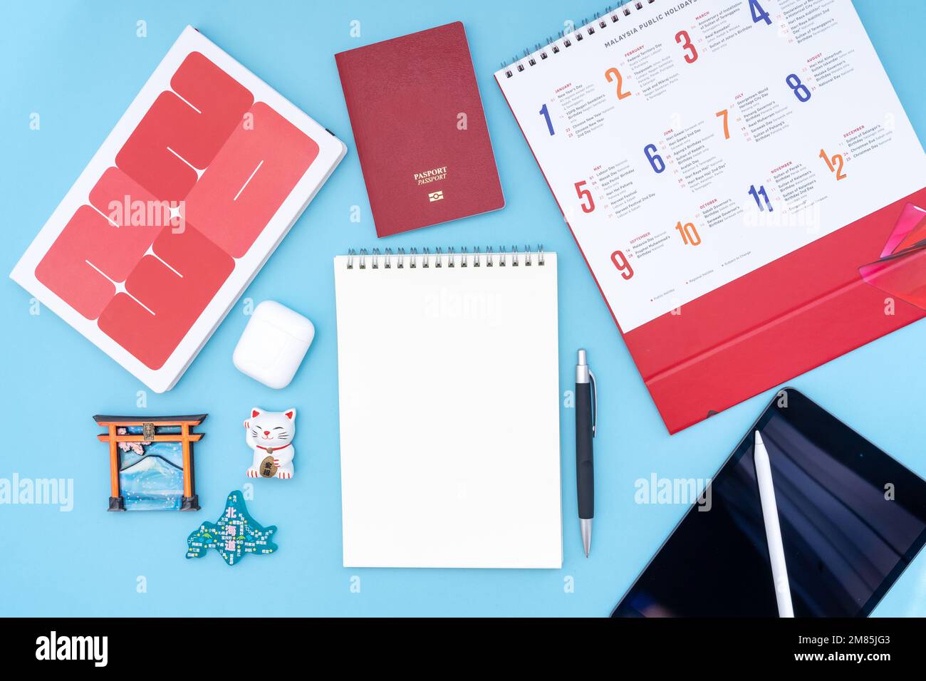 Vacation, trip or holiday planning concept to Japan - Public Holiday calendar with notepad, pen, earphone, and tablet on blue background. Stock Photo
