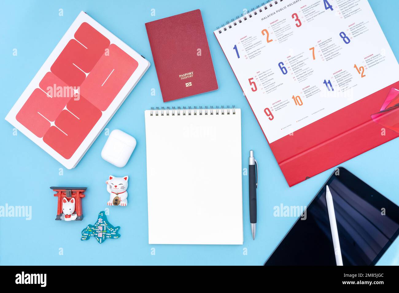 Vacation, trip or holiday planning concept to Japan - Public Holiday calendar with notepad, pen, earphone, and tablet on blue background. Stock Photo