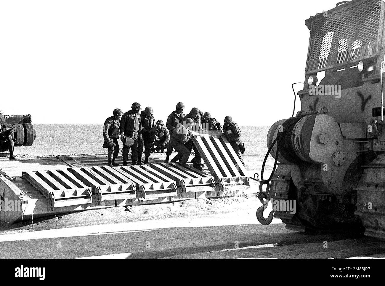 Members of Amphibious Construction Battalion 2 lift sections of a causeway during Exercise ELCAS (Elevated Causeway), a training exercise in which Seabees learn pier-construction techniques. Subject Operation/Series: ELCAS (ELEVATED CAUSEWAY) Base: Naval Air Station, Norfolk State: Virginia (VA) Country: United States Of America (USA) Stock Photo