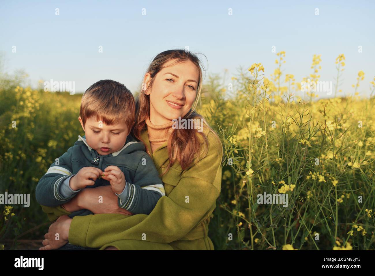 Mother and son in a rapeseed field Stock Photo