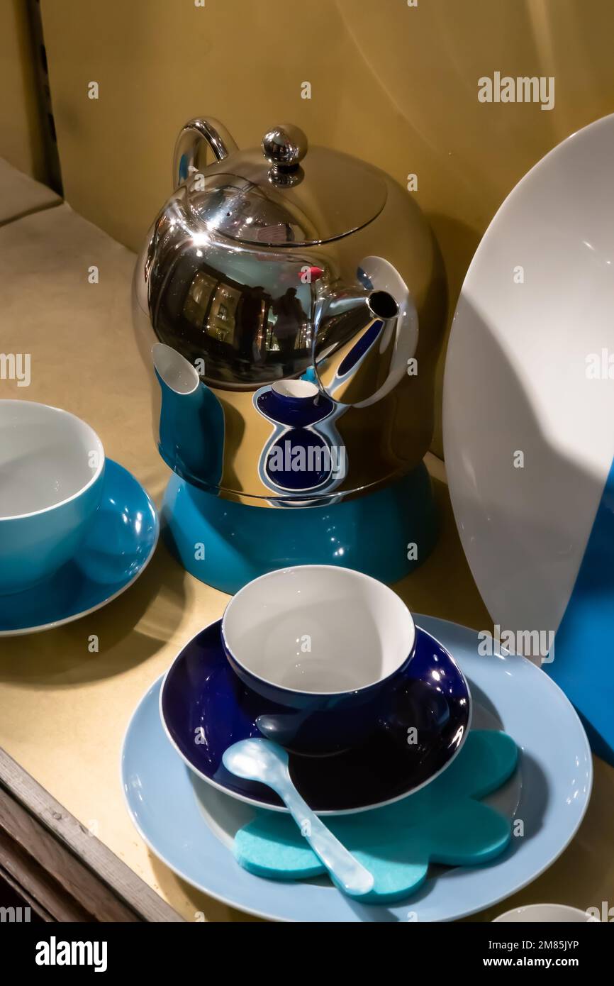 https://c8.alamy.com/comp/2M85JYP/a-shiny-silver-teapot-with-contrasting-blue-and-white-cups-and-saucers-with-teaspoon-and-coaster-in-a-viennese-window-display-vienna-2M85JYP.jpg