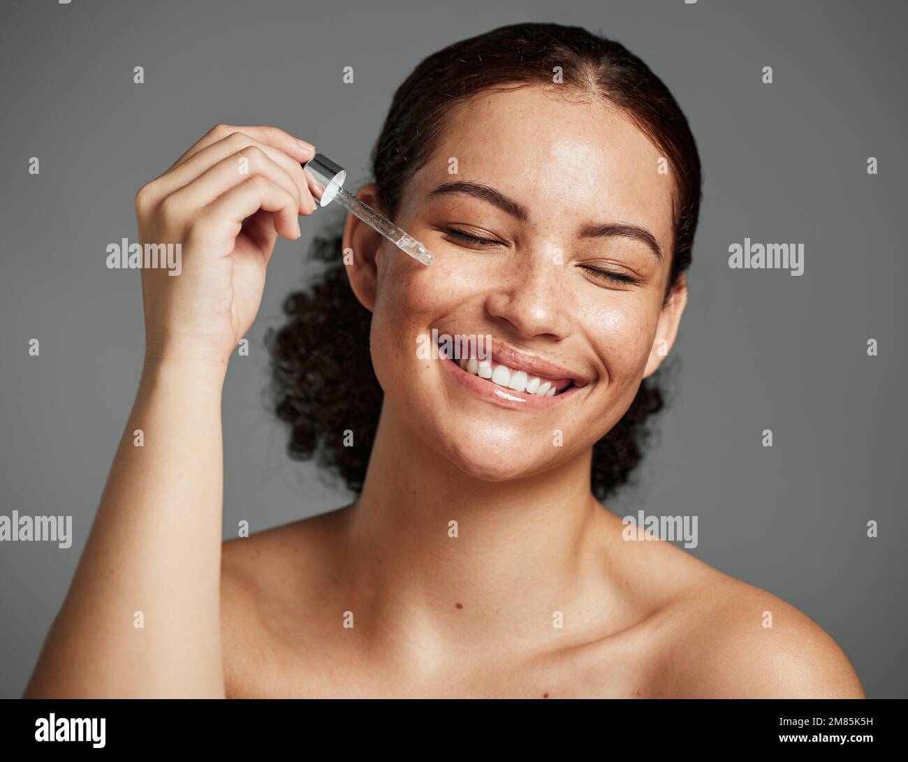 Beauty, skincare and serum with face of woman for facial, product or self care with morning routine. Luxury, health and wellness with girl model and Stock Photo