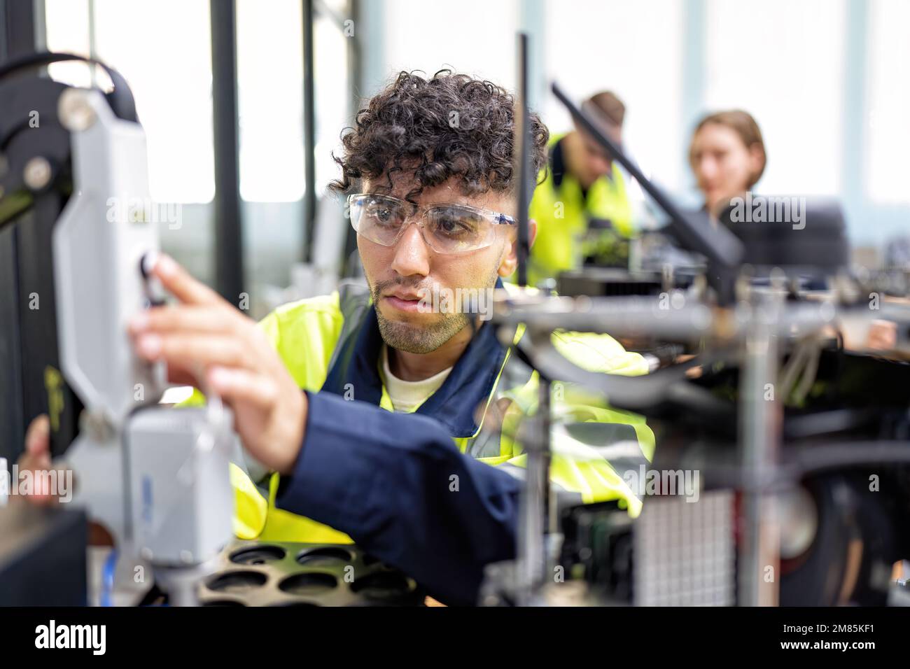 Engineer learn basic theory how to operation maintenance and programing robot arm in training room Stock Photo