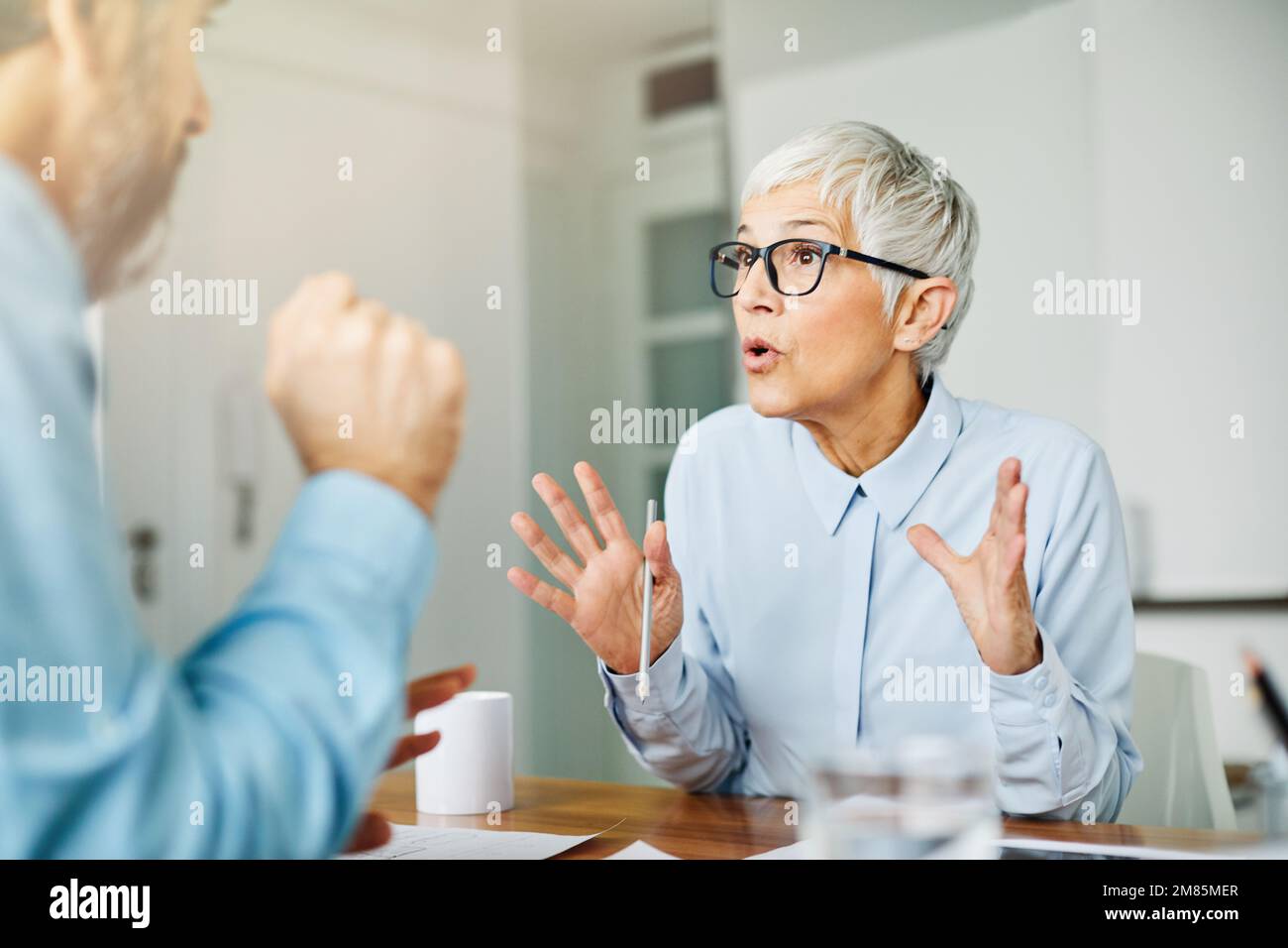 business office person discussion document papers teamwork senior meeting Stock Photo