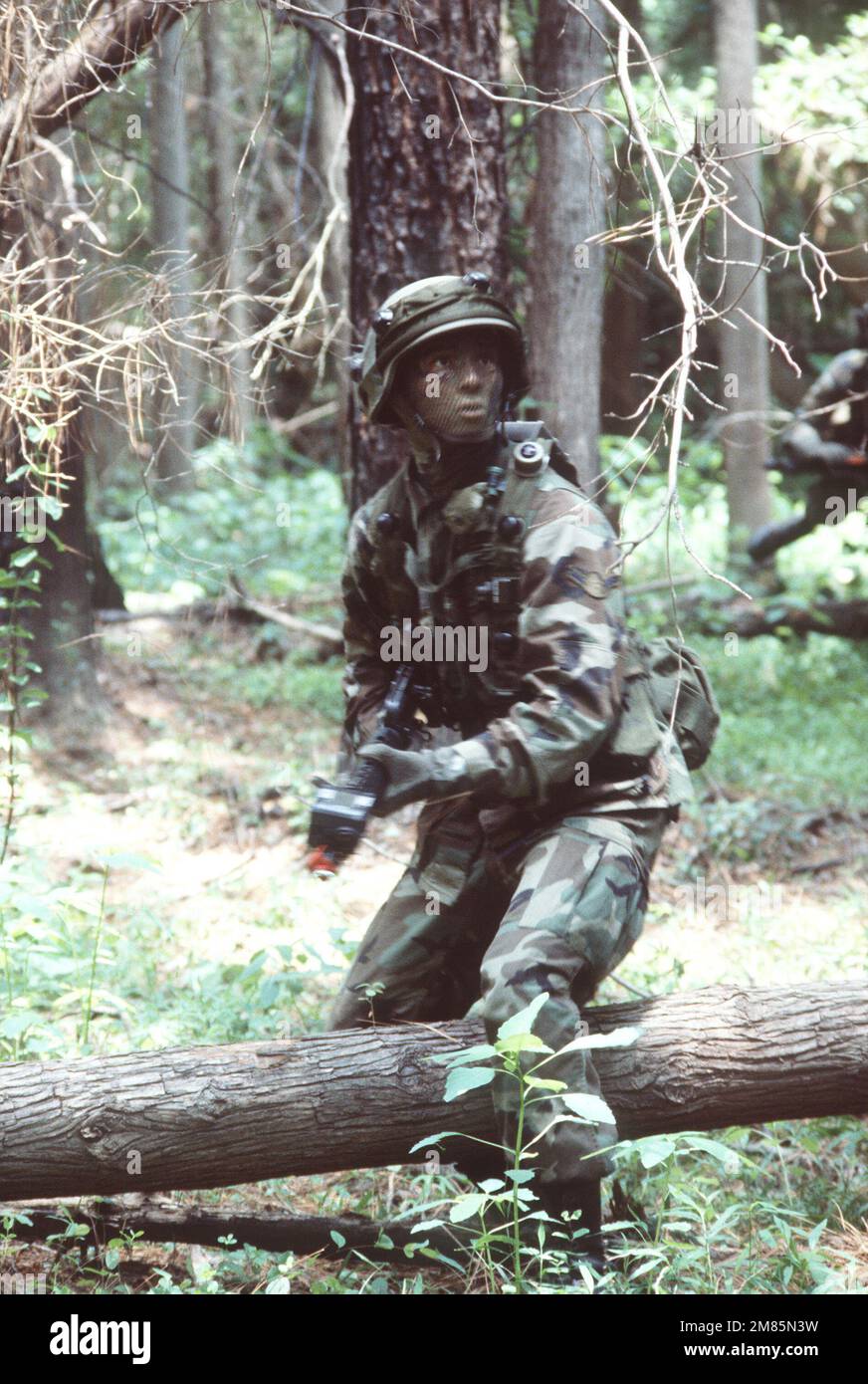 AIRMAN Simon Amador, a member of security police team, covers the ...