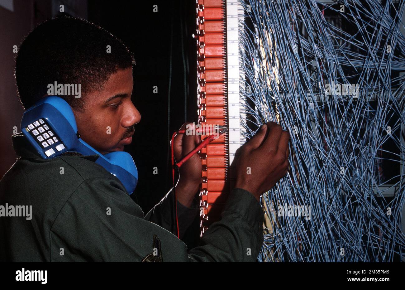 AMN Brian Williams, electrical/mechanical telephone switching specialists with the 1995th Information Systems Squadron, troubleshoots a telephone line using the central test facility's main distribution frame. Base: Eielson Air Force Base State: Alaska (AK) Country: United States Of America (USA) Stock Photo