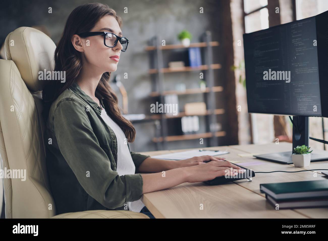 Photo of confident smart lady safety expert wear spectacles debugging new system indoors workplace workshop Stock Photo
