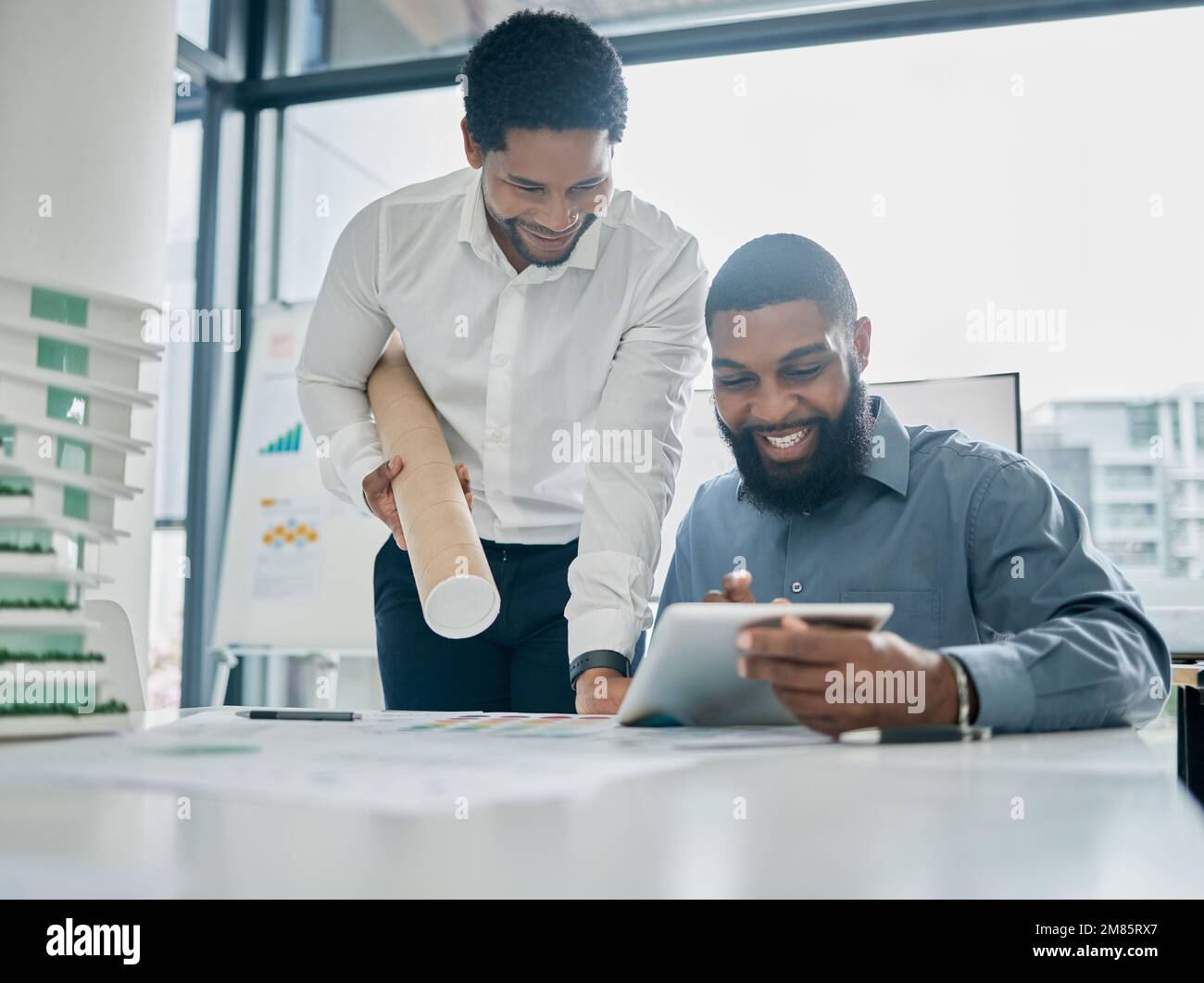 Tablet, architecture and collaboration with a business black man architect team working in their office. Building, design or teamwork with a male Stock Photo