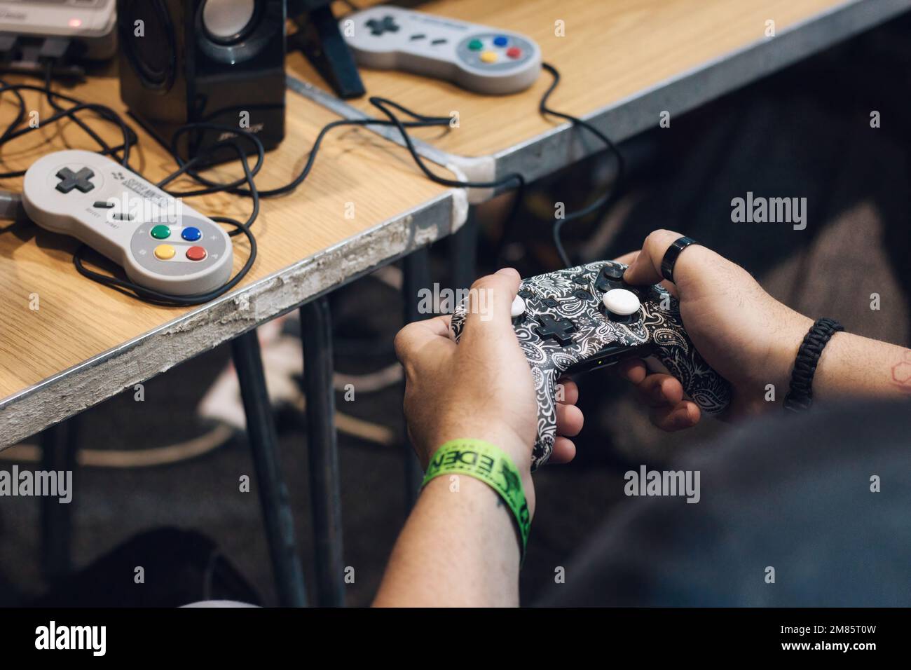 06 November 2022 - TaQali, Malta: Hands of a man playing a video game with a PlayStation controller Stock Photo