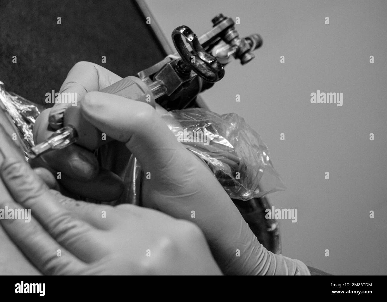 Premium Photo  Hand of a tattooist holding the tattoo gun