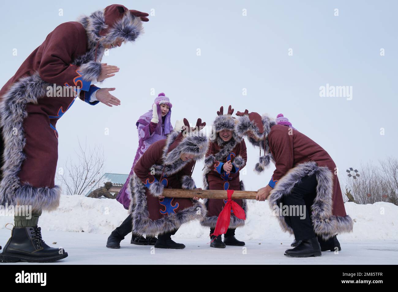 Fuyuan, China's Heilongjiang Province. 11th Jan, 2023. A group of Hezhe young people play 'Ding Gang', a Hezhe traditional sport, in Wusu Town of Fuyuan City, northeast China's Heilongjiang Province, Jan. 11, 2023. The Hezhes, one of the smallest ethnic minority groups in China, hold various activities to welcome the upcoming Chinese Lunar New Year. Credit: Wang Jianwei/Xinhua/Alamy Live News Stock Photo