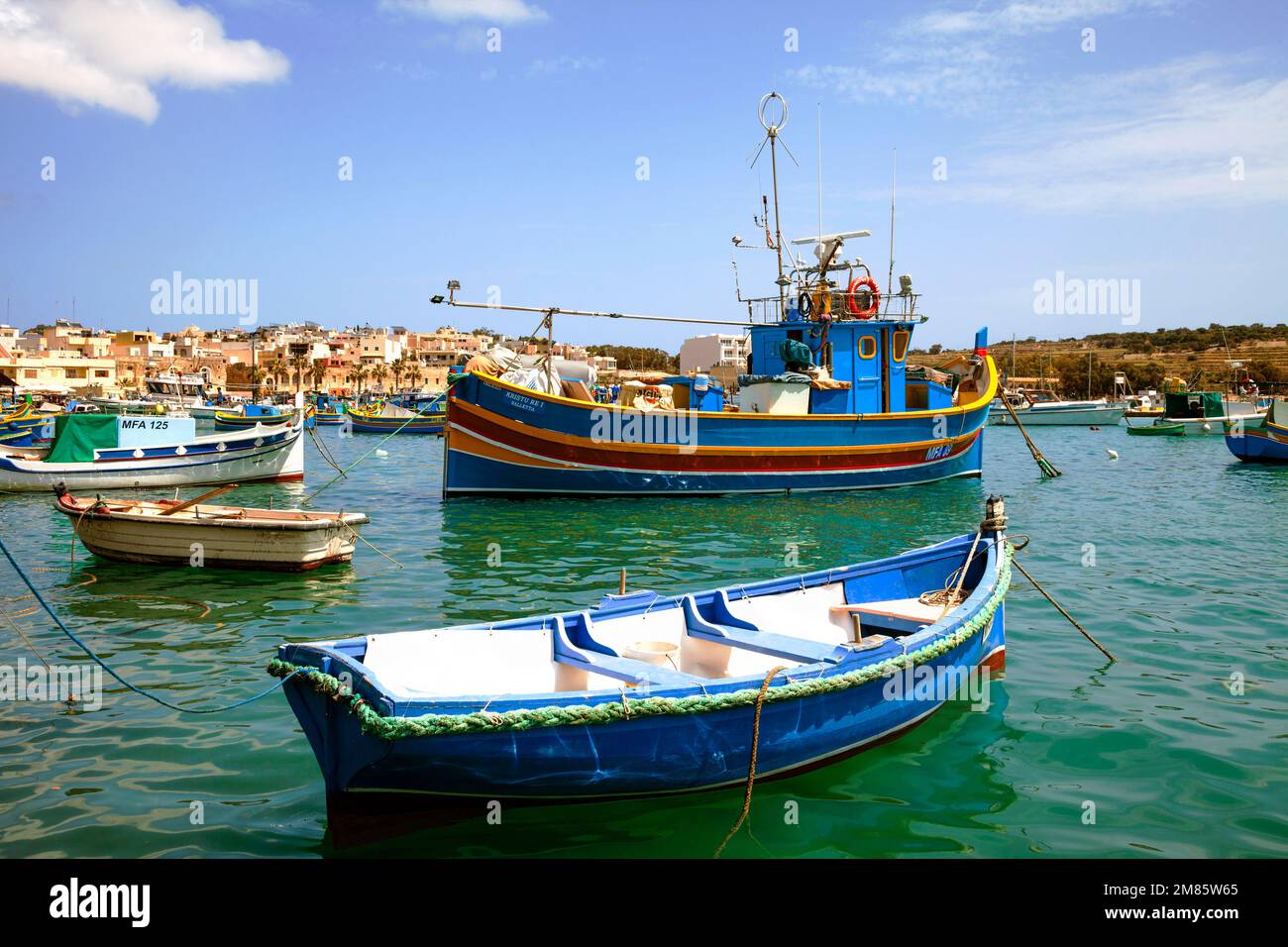 Luzzus, the typical colorful fishing boats of Malta, in the harbor of