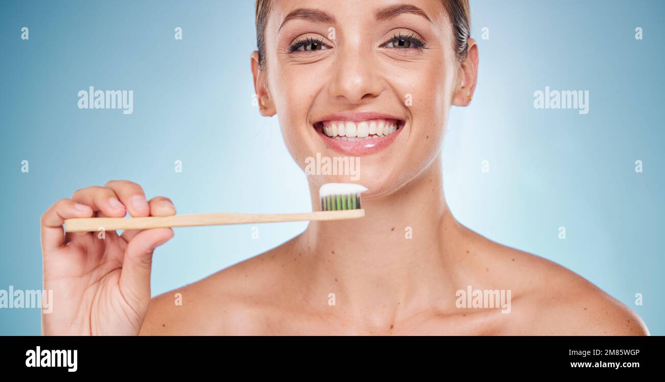 Brushing teeth, dental and woman with toothbrush for teeth whitening and beauty, oral health and fresh breath with studio background. Mouth wellness Stock Photo