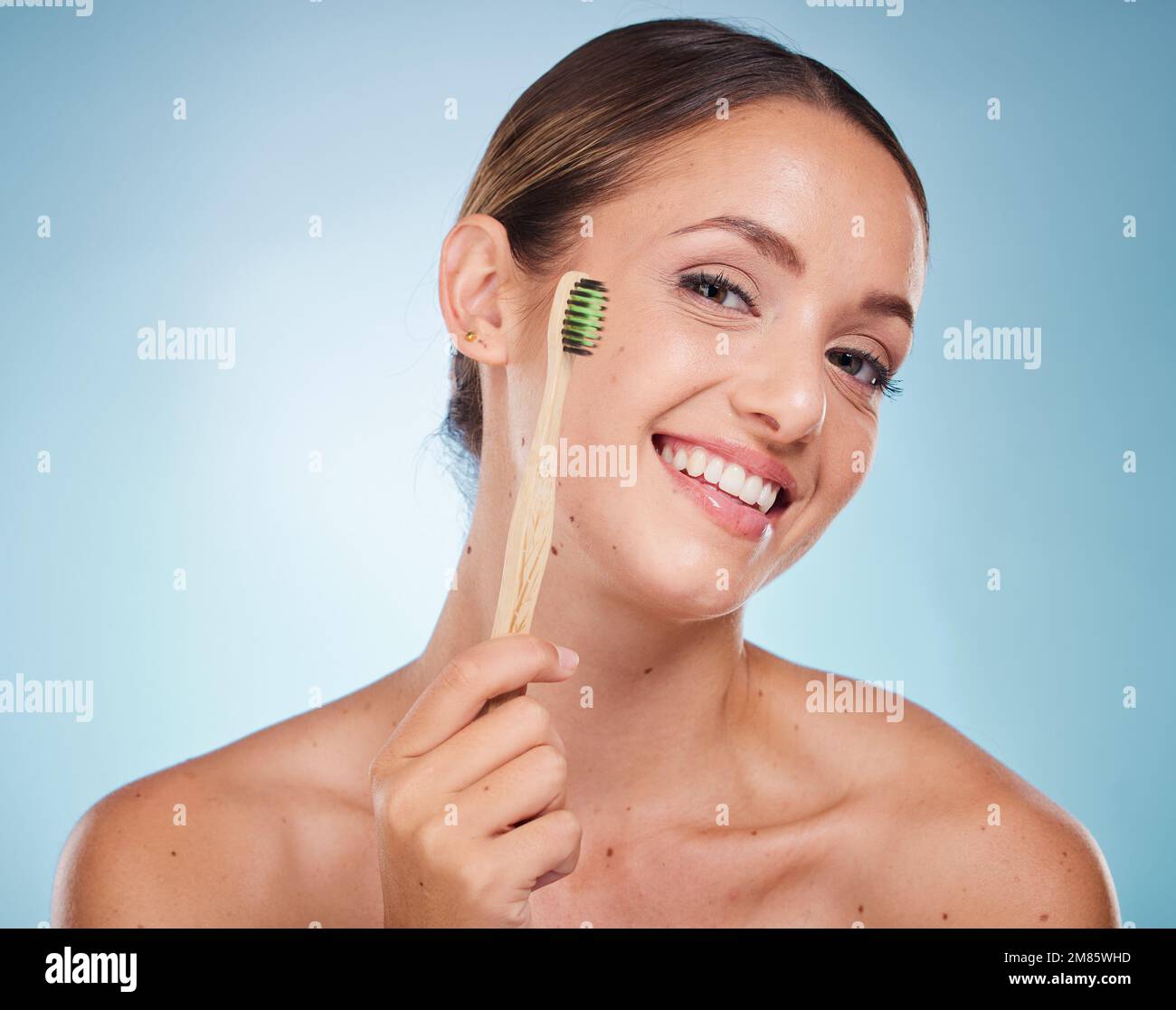 Brushing teeth, dental and woman with toothbrush for teeth whitening and beauty, oral health and fresh breath with studio background. Mouth wellness Stock Photo