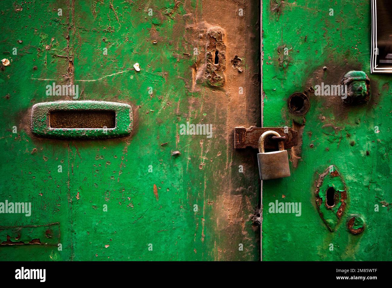 rusty door lock with deadbolt, on weathered wooden door, Valletta
