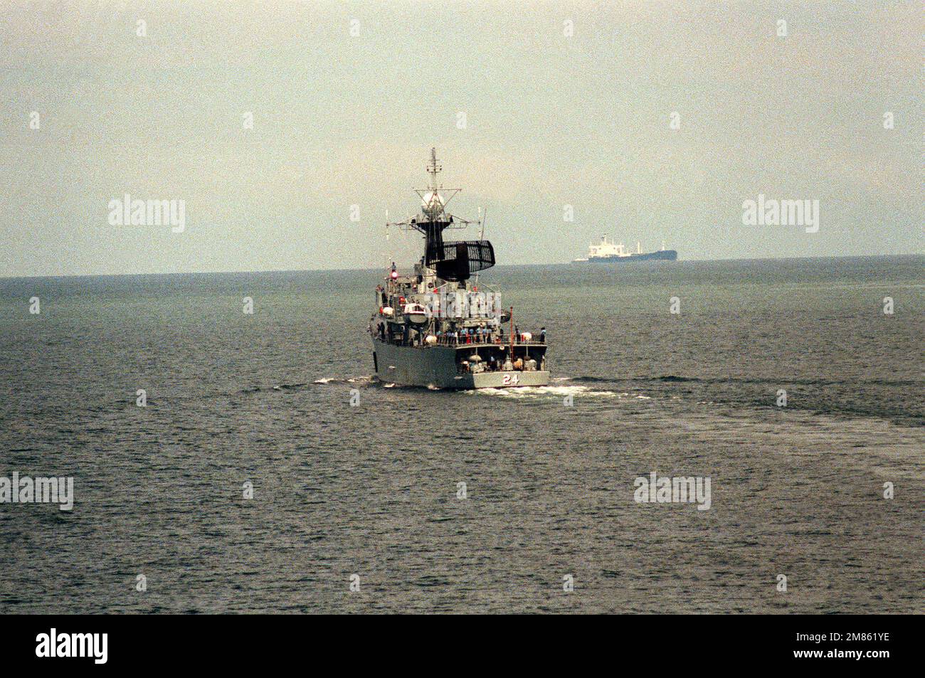 A port quarter view of the Malaysian frigate KD RAHMAT (24) undeway. Country: Singapore Strait Stock Photo