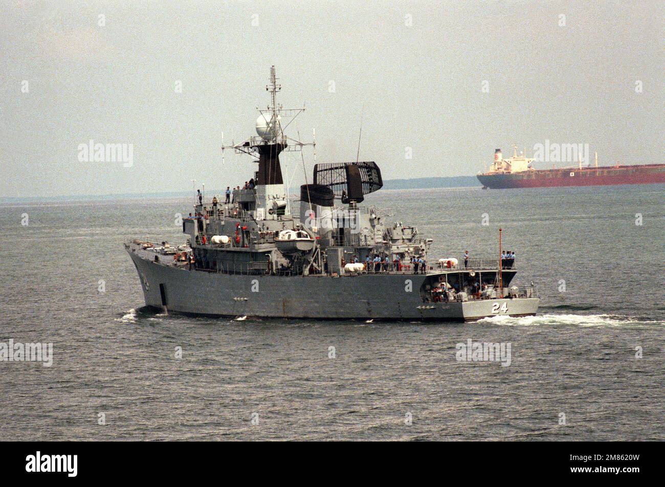 A port quarter view of the Malaysian frigate KD RAHMAT (24) undeway. Country: Singapore Strait Stock Photo