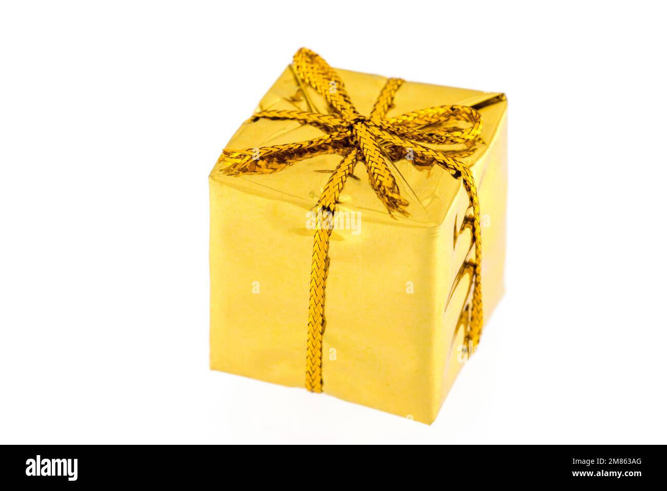 Gift box of gold color isolated on white background Stock Photo - Alamy