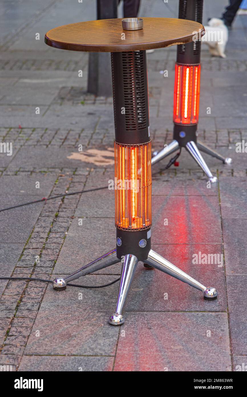 Infrared Lamp Electric Outdoor Heater Built in Table Leg at Street Stock Photo