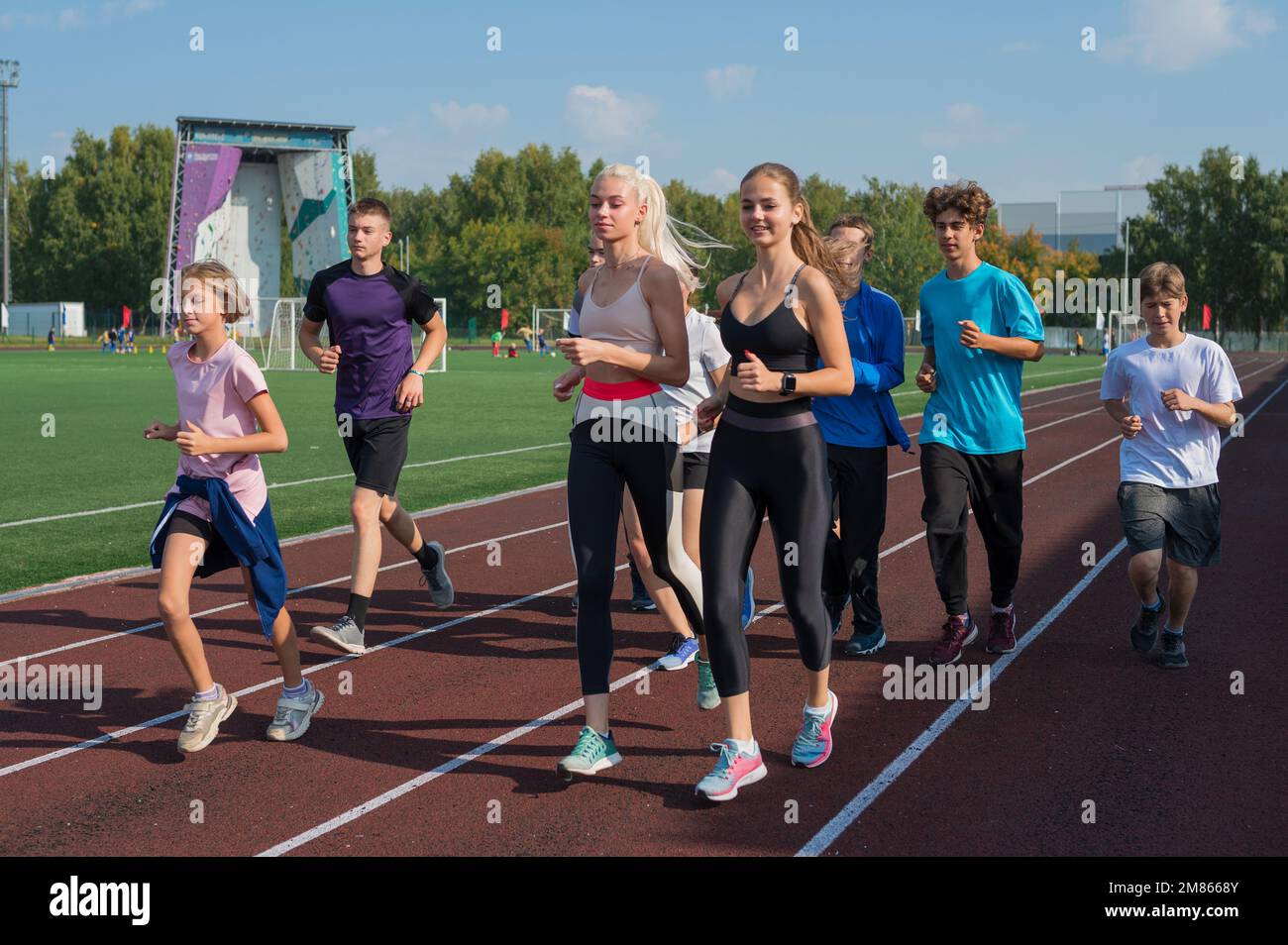 Group of young athletes training at the stadium. School gym trainings