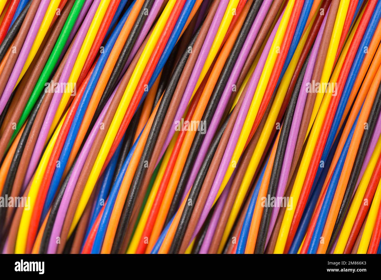 Close-up shot of multi-colored narrow gauge electrical wire wrapped round a former (so image centre reasonable flattened). For colour identification. Stock Photo