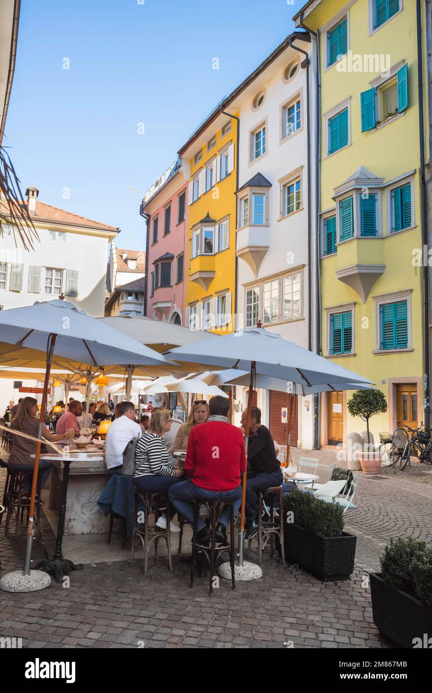 Bolzano bar, view of people relaxing at tables outside a bar in a street in the historic old town center of Bolzano, Italy Stock Photo
