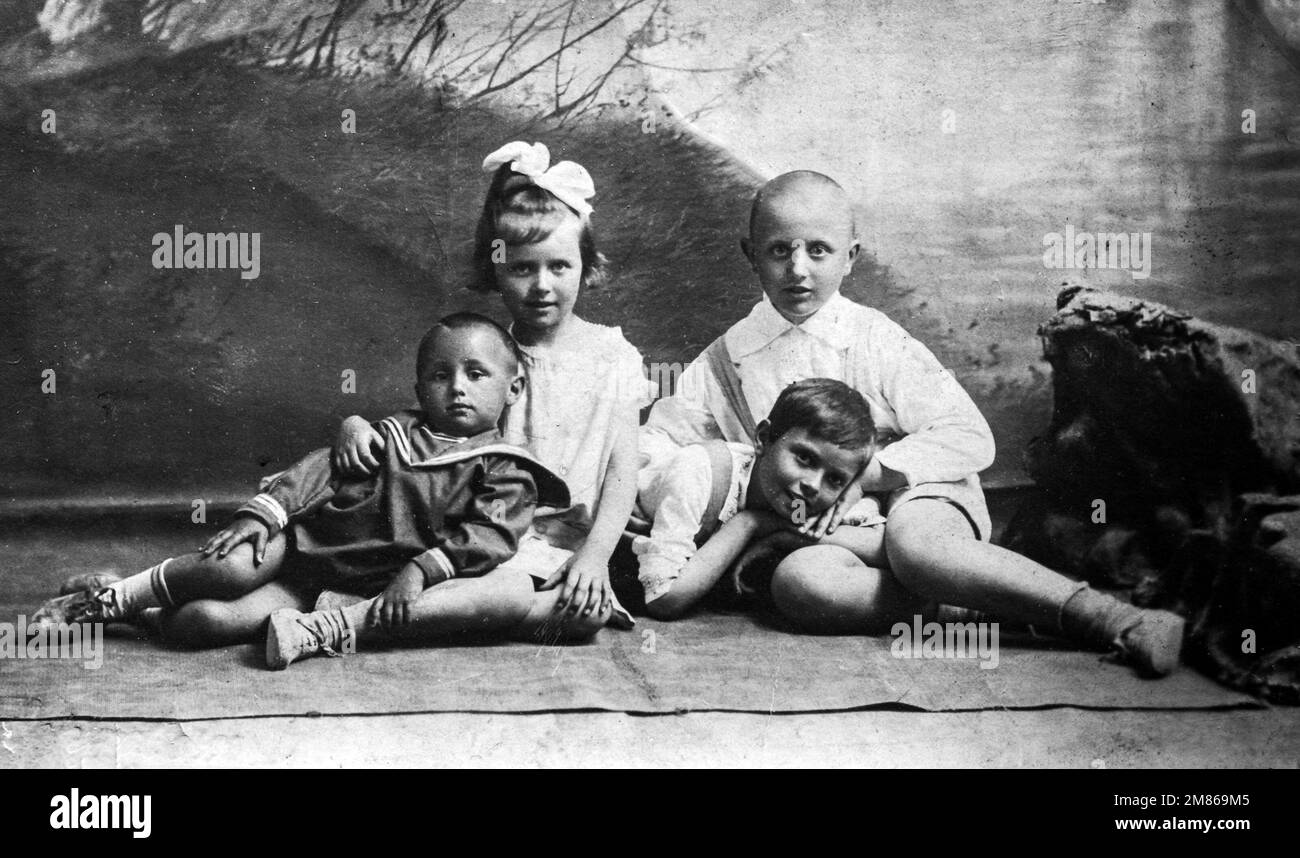 Location unknown, Russian Empire - circa 1910: group photo four children from same family Stock Photo