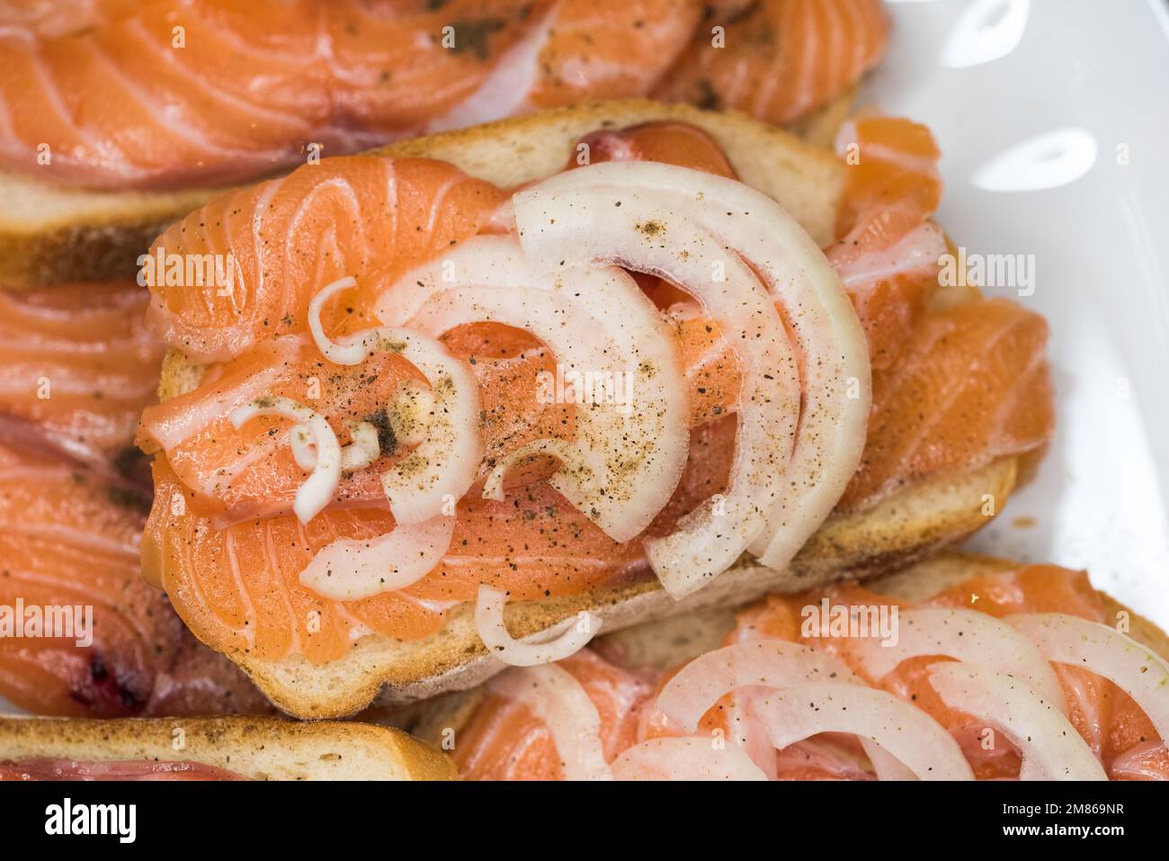 Bread with fresh salted salmon fillet isolated on white background, top view Stock Photo