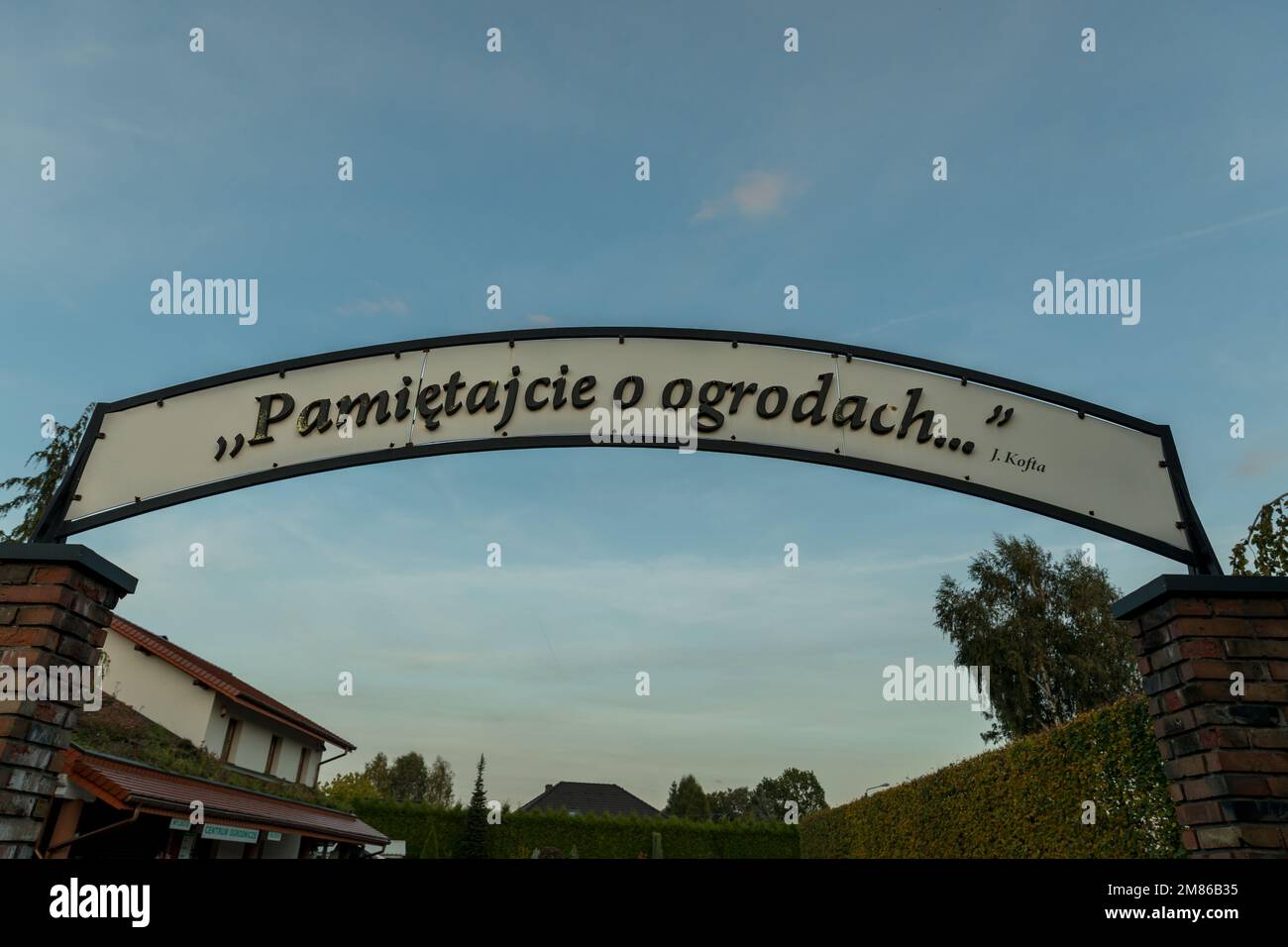Signboard With Inscription Signboard above the entrance gate with the inscription in Polish ...