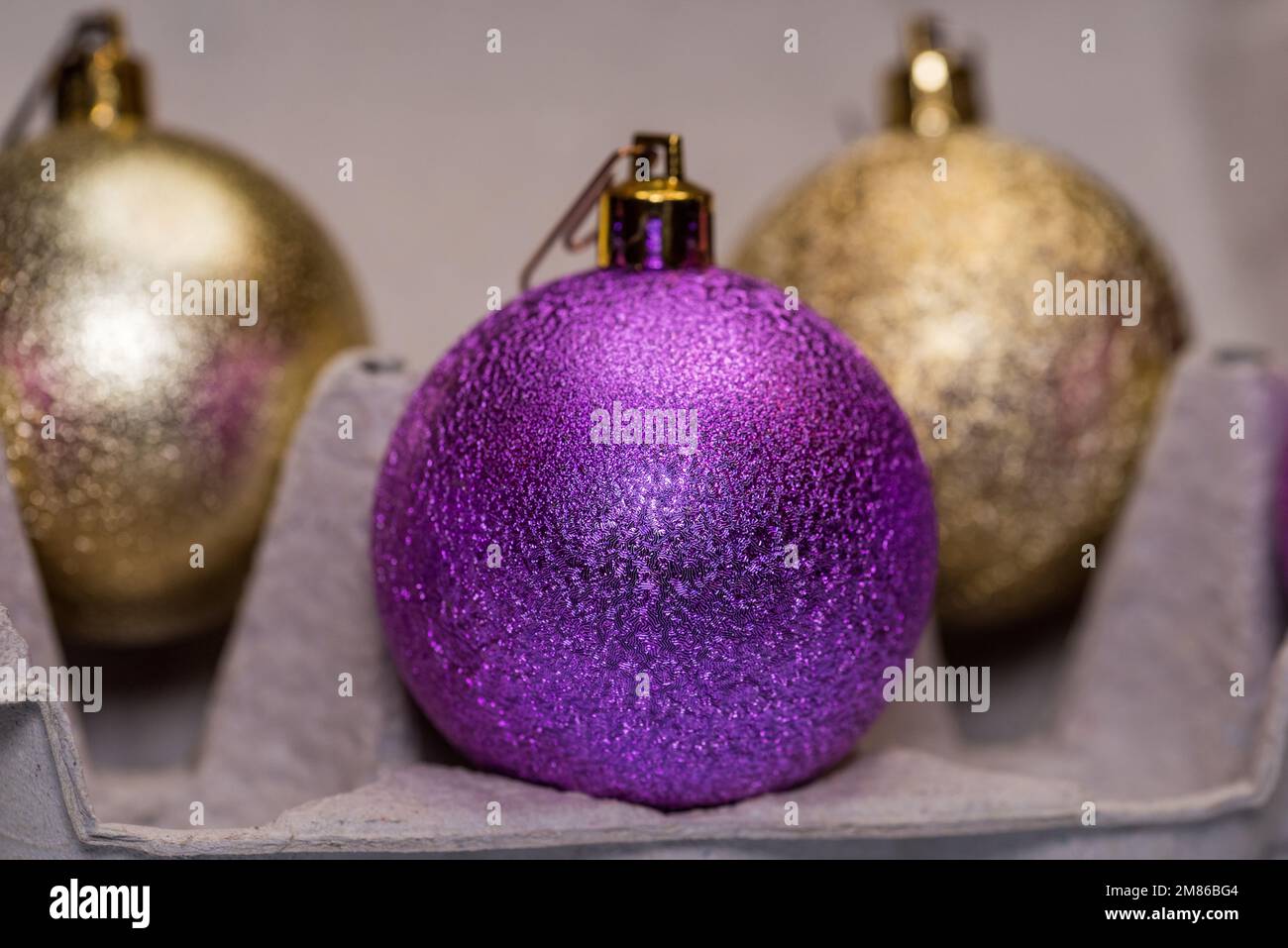 Christmas tree glitter balls in egg carton box. Easter and New Year concept Stock Photo