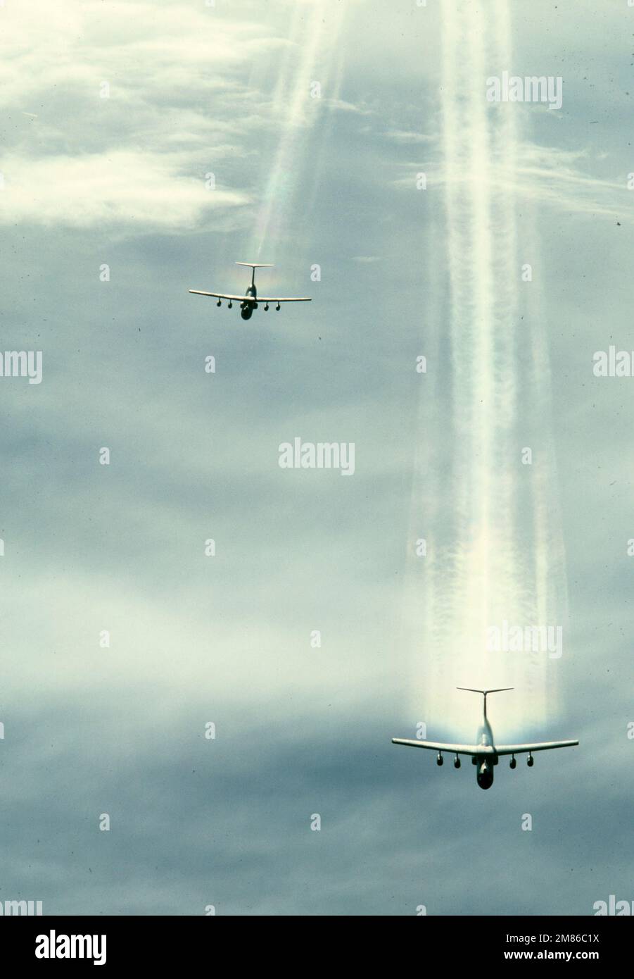 Air to air top, front view of two Air Mobility Command's C141