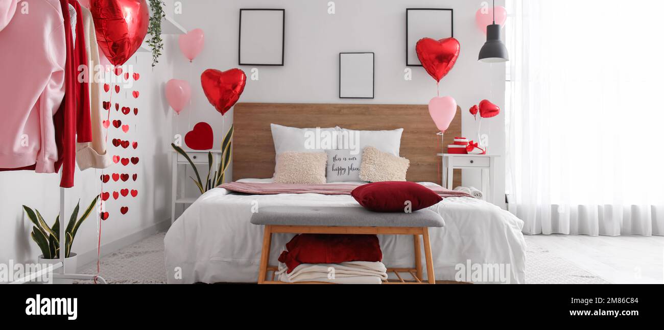 Interior of light bedroom with gifts and balloons for Valentine\'s ...
