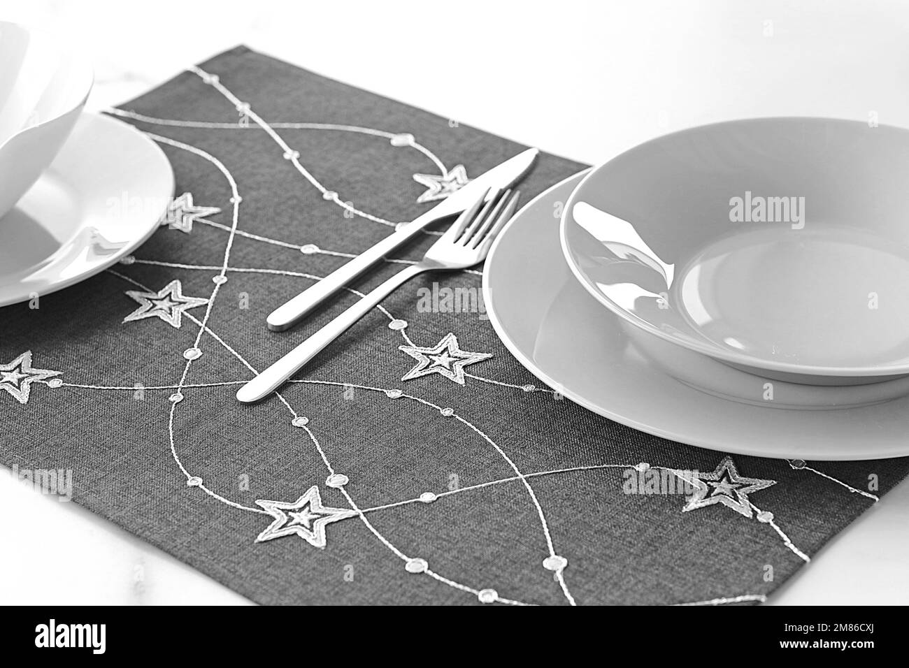 Table runner, napkin or kitchen placemat on cloth isolated or with plate, cutlery and glasses Stock Photo
