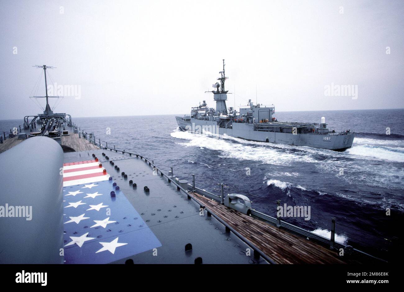 A port quarter view of the frigate USS MOINESTER (FF-1097) underway ...
